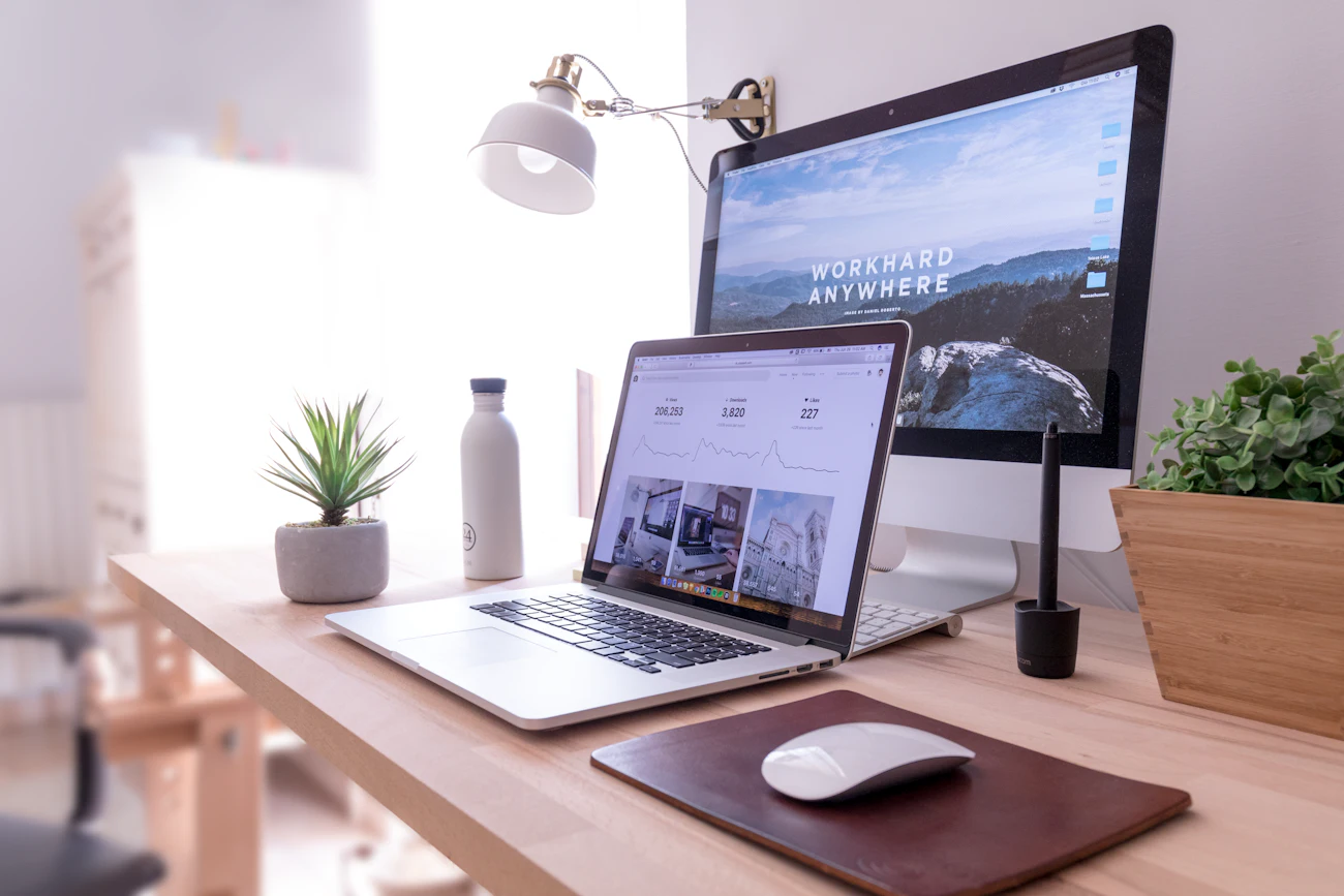 Portátil y pantalla con una página web en un escritorio de trabajo